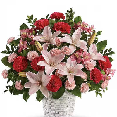 Pink lilies and red carnations in a white woven vase