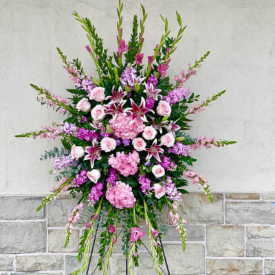 Large pink and white standing floral spray on an easel