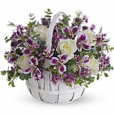 Basket arrangement of white roses and purple orchids