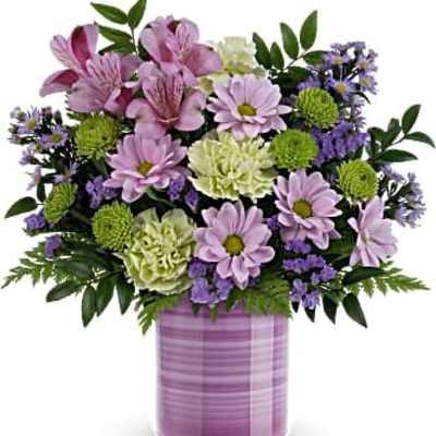 Pastel bouquet of pink alstroemeria, lavender daisies, and green blooms in a striped lavender vase
