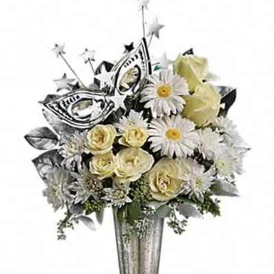 White and cream roses and daisies in a tall silver vase with a silver masquerade mask decoration