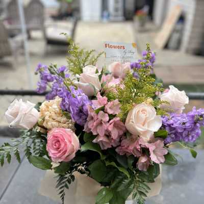 Bouquet of pink and white roses with purple flowers