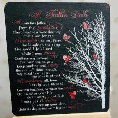 Memorial plaque with a poem and white tree graphic on a black background