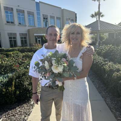 Couple holding a bouquet of white and blush flowers