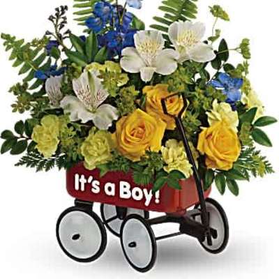 Yellow, white, and blue flower arrangement in a small red wagon with 'It's a Boy!' text.