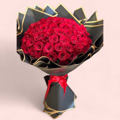 Bouquet of red roses wrapped in black paper with gold trim