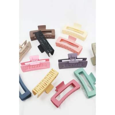 Assorted pastel and neutral hair claw clips on a white background