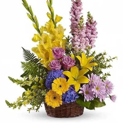 Colorful mixed flower arrangement in a wicker basket