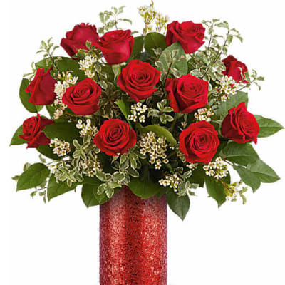 Red roses arranged in a red glitter vase