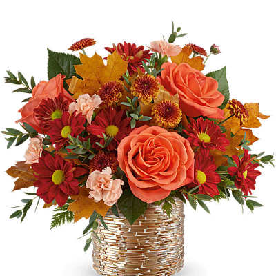 Autumn bouquet of orange roses and red daisies in a gold vase