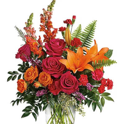 Mixed bouquet of roses and lilies in a clear glass vase