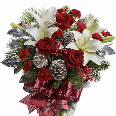 Red roses and white lilies in a glass vase with a red ribbon