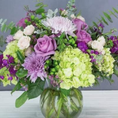 Bouquet of purple and white flowers in a glass vase