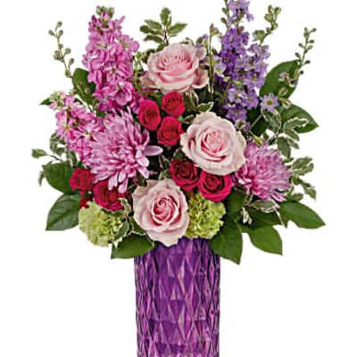 Tall purple vase with pink roses, mums, spray roses, and purple flowers