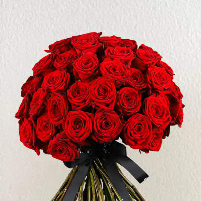 Bouquet of red roses tied with a black ribbon