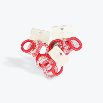 Assorted red and pink spiral hair ties on display cards