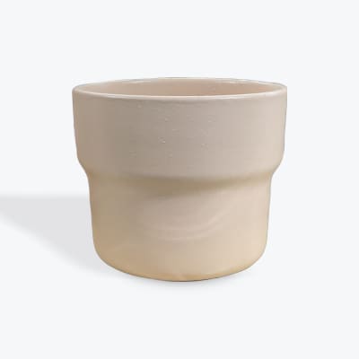 Beige ceramic planter or vase with a rounded shape