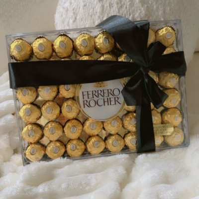 Box of Ferrero Rocher chocolates tied with a black ribbon