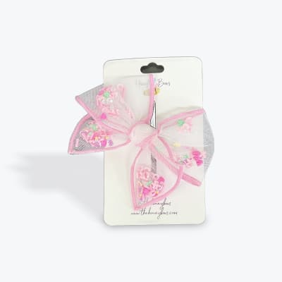 Pink mesh hair bow on a retail card