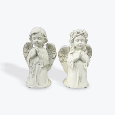 Two white angel figurines with folded hands
