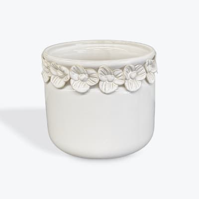 White ceramic planter with raised floral trim