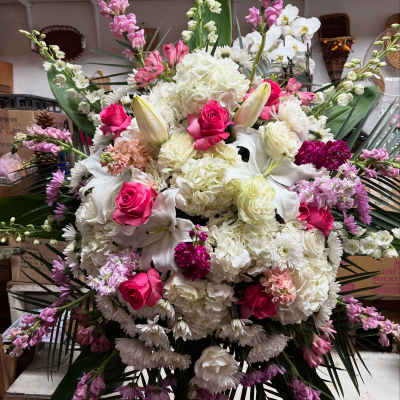 Large bouquet of white lilies, pink roses, and white hydrangeas with purple accents