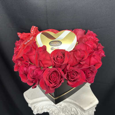 Heart-shaped box of red roses with a Ferrero Collection chocolate box on top