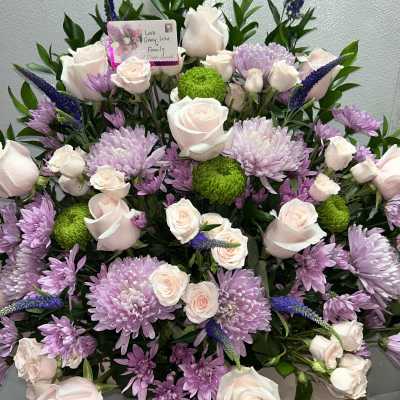 Large bouquet of pale pink roses, lavender chrysanthemums, and green button mums