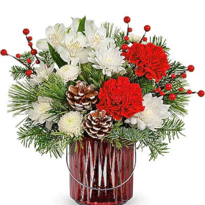 Holiday bouquet of red and white flowers in a red glass vase