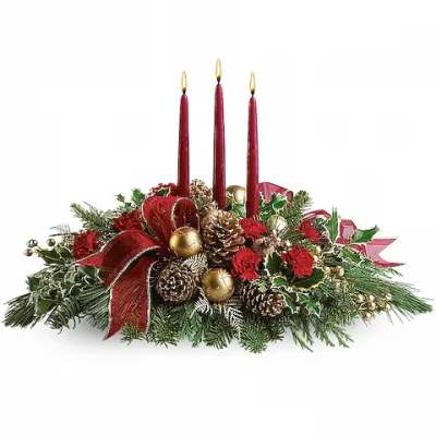 Christmas centerpiece with red candles, pinecones, and red flowers