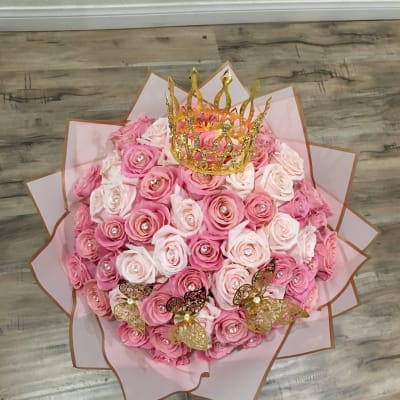 Pink rose bouquet with a gold crown topper and butterfly accents