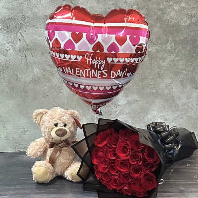 Red rose bouquet with a teddy bear and heart-shaped Valentine balloon