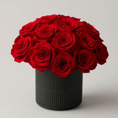 Red roses arranged in a black ribbed vase