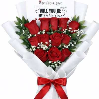 Bouquet of red roses wrapped in white paper with a red ribbon