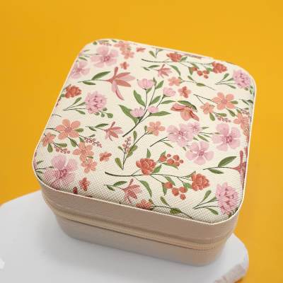 Floral-patterned square zippered case on a yellow background