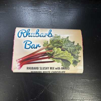 Box of Rhubarb Bar chocolate on a dark surface