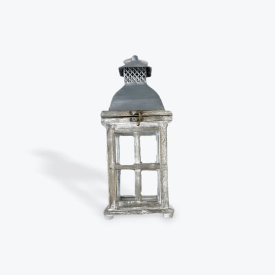 Decorative silver lantern with glass panels and a metal top