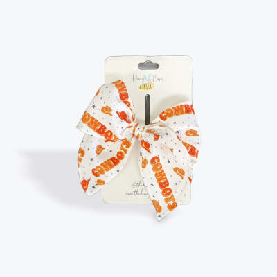 Orange and white patterned bow on retail packaging
