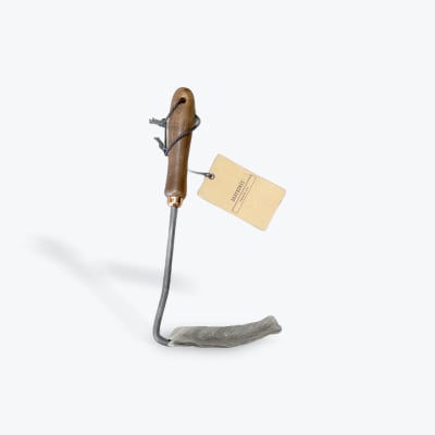 Wood-handled metal garden tool with a hanging tag