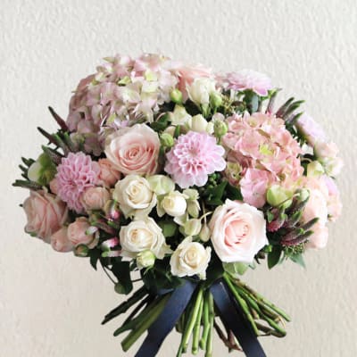 Bouquet of pale pink and white roses with hydrangeas and dahlias