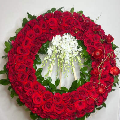 Large red rose wreath with white orchids in the center