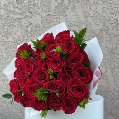 Bouquet of red roses wrapped in white paper