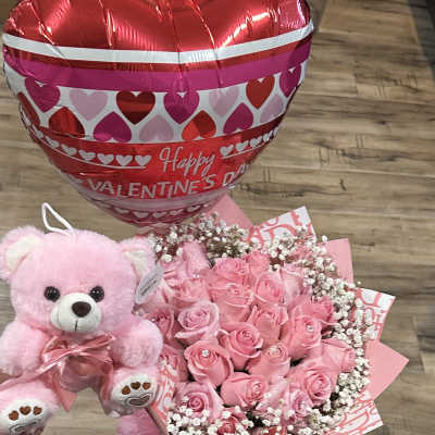 Pink rose bouquet with a teddy bear and heart-shaped Valentine balloon