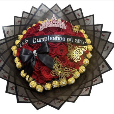 Bouquet of red roses with a tiara, black ribbon, and gold chocolates