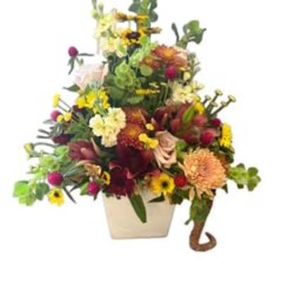 Colorful mixed flower arrangement in a white vase