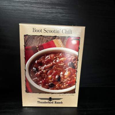 Box of Boot Scootin' Chili mix on a dark surface