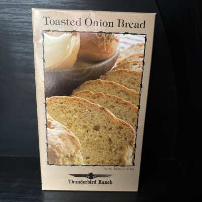 Box of toasted onion bread on a dark surface