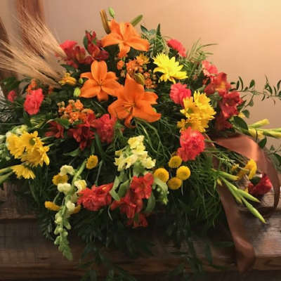 Colorful floral arrangement with orange lilies and yellow daisies