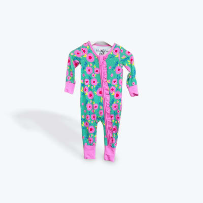 Floral baby onesie with pink trim on a white background