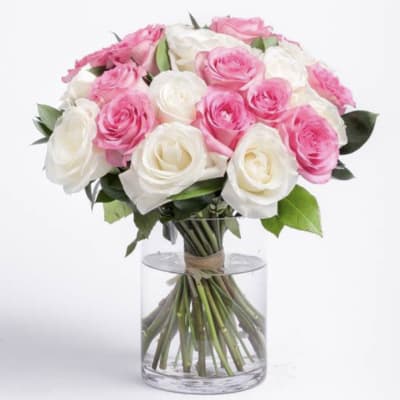 Bouquet of pink and white roses in a clear glass vase